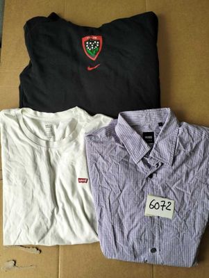 three shirts are sitting on a cardboard box on a table