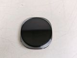 an image of a black button on a white surface