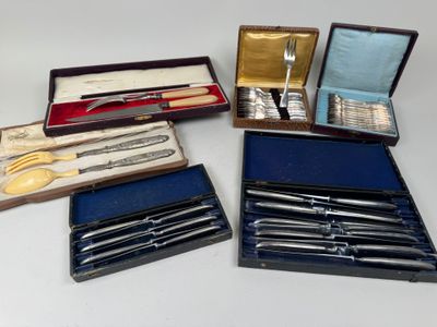 plusieurs types d'argenterie dans un coffret posé sur une table