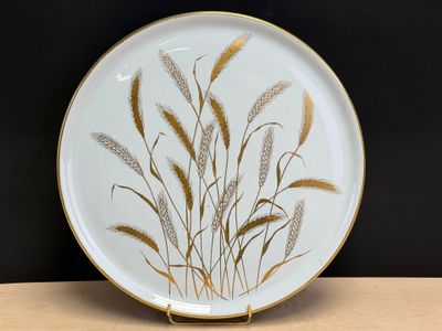 an image of a decorative plate with wheat on it on a table