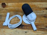 a microphone and a charger sitting on a wooden table