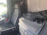 two seats in the back of a van with a bag on the seat