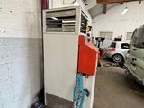 a red and white air conditioner sitting in a garage