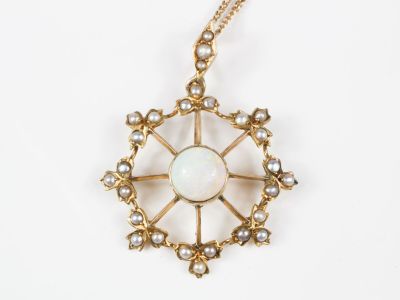 Chaîne en or et son pendentif roue centrée d'une opale caboc…