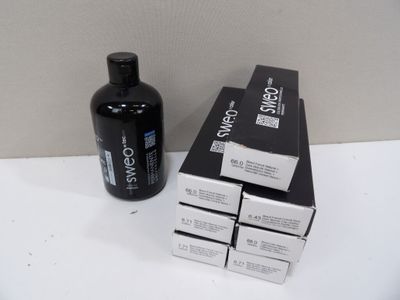 a bottle of shampoo next to a box of shampoos on a table