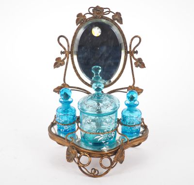 a blue glass set on a stand with a mirror in the background