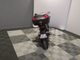 a motorcycle that is parked in a room with a checkered floor