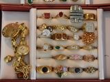 many different rings and bracelets in a box