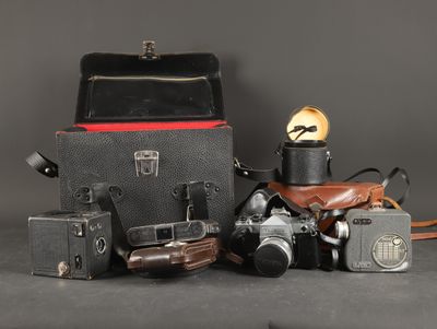 many different types of cameras sitting on a table