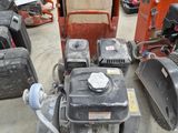 several lawn mowers are lined up in a lot with other lawn mowers in the background