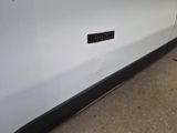a sticker on the side of a white car that has a sticker on it