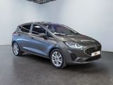 a grey ford fiesta parked in a showroom
