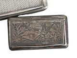a silver box with a bird on it next to another box