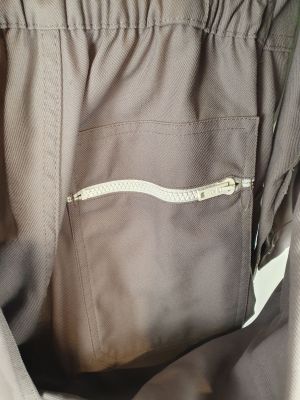 a close up of a person ' s pants with a zipper in the pocket