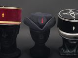 three hats are sitting next to each other on a black surface