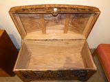 a wooden chest with a lid that is open