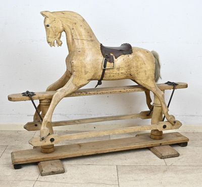 a wooden rocking horse with a saddle on it
