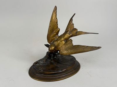 a bronze statue of two birds sitting on a base