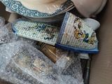 a box full of items that include a teapot, a clock, and other items