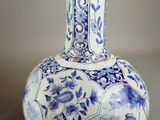 a blue and white vase sitting on a table