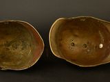 two brown bowls sitting side by side on a black surface