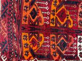 an image of a red and orange rug with a pattern on it