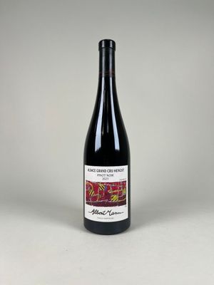 une bouteille de vin rouge posée sur une table blanche