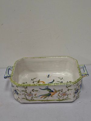 a white and green bowl with a bird design on it