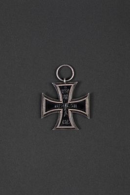 an iron cross pendant with a black and silver cross on it