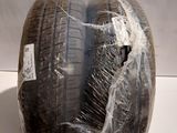 a tire wrapped in plastic on a white surface