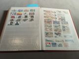 an open book with stamps on it sitting on a table