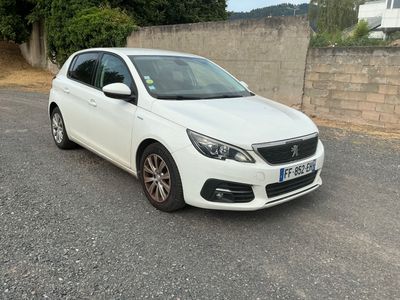 the small white car is parked on the side of the road