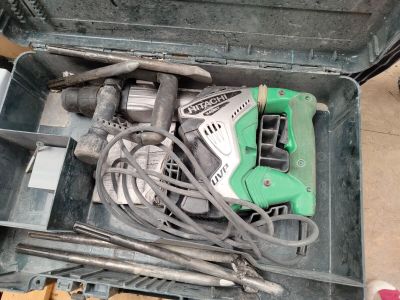 une boîte à outils contenant des outils, posée sur le sol