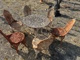quatre chaises et une table au milieu d'un champ