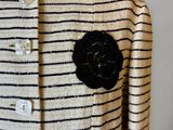 an image of a woman ' s jacket with a flower on it