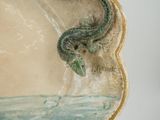 someone is holding a plate with a painting of a sea creature on it
