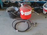 a red fire extinguisor sitting on the floor next to buckets