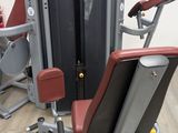 a gym machine that is sitting on a wooden floor
