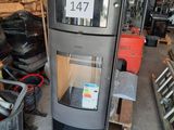 a picture of a stove in a warehouse with a sign on it