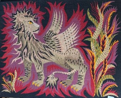 une broderie au point de croix représentant un lion sur fond noir