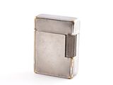 briquet argenté sur fond blanc, posé sur une surface blanche
