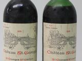 two bottles of red wine sitting next to each other on a table
