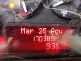 a digital clock on the dashboard of a car