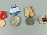 four medals and a medal on a white surface with a red star