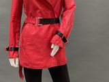 an image of a mannequin dressed in a red coat and black leggings
