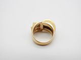 a close up of a gold ring on a white surface