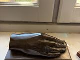 a statue of a hand with a glove on a table