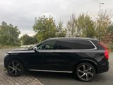 the black volvo suv is parked in the parking lot