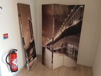 a room divider with a picture of a bridge and fire extinguisher