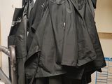a bunch of umbrellas hanging on a rack in a room